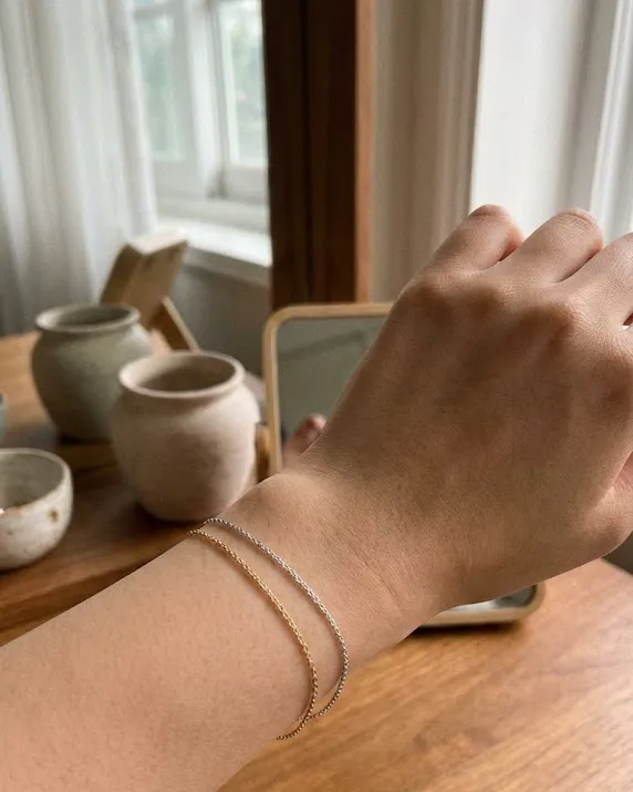 웜톤 쿨톤 테스트를 위해 손목에 골드와 실버 팔찌를 대보는 모습